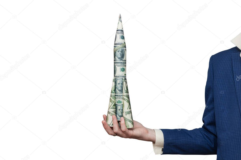 Man in a business suit holds a rocket of paper dollars