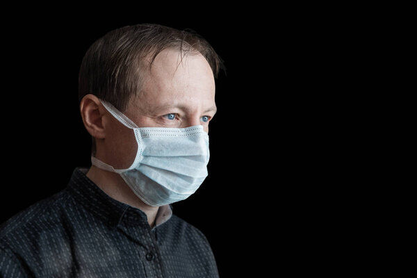 Man in a medical bandage on an isolated black background. 