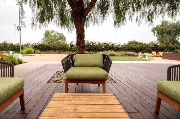 Wood patio lounge chairs with green cushions — Stock Photo, Image