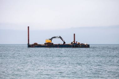 Excavator and dredging equipment at Wiggins Pass clipart