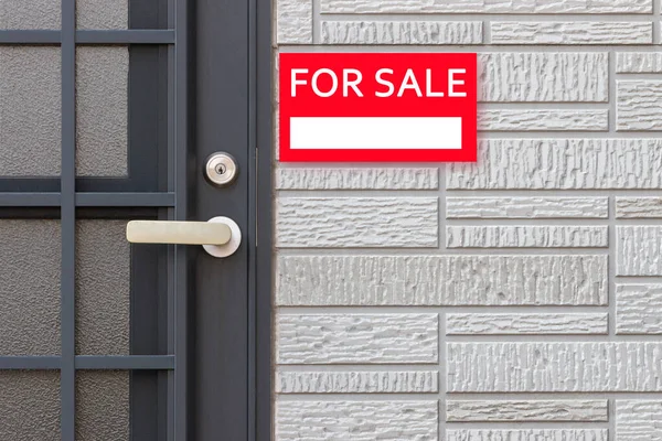 For sale, real estate signboard on wall. — Stock Photo, Image