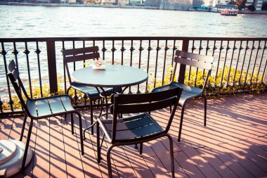 Balkondaki Sandalye ve Masa / Masa Choa Praya Nehri 'ni temsil ediyor..