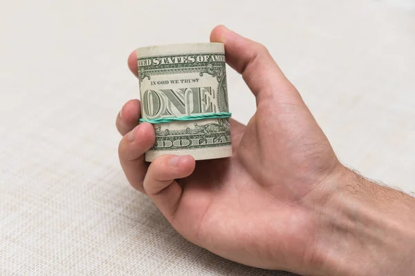 Egy ember tart egy köteg pénzt, a kezében egy gumiszalaggal kötött — Stock Fotó