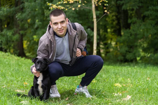 Man with a dog on the grass — Stock Photo, Image