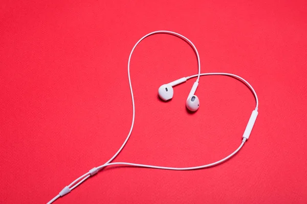 White headphones lined in the form of a heart — Stock Photo, Image