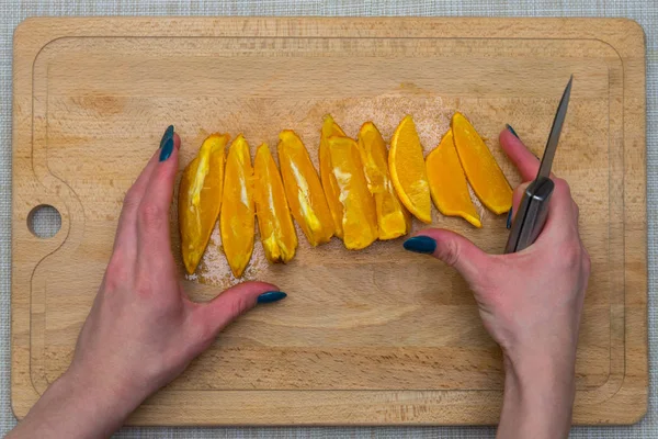 Cutted orange on a wooden board — Stock Photo, Image