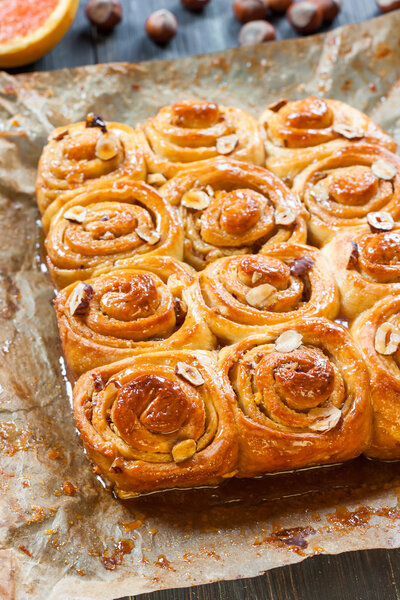 Cinnamon rolls with nuts on the table. Freshly Cinnabon in the form of.