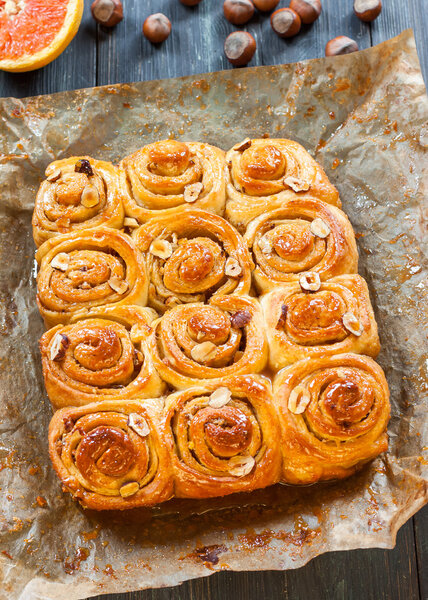 Cinnamon rolls with nuts on the table. Freshly Cinnabon in the form of.
