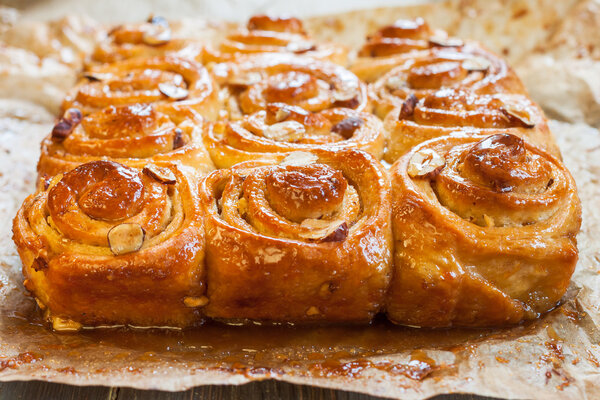 Cinnamon rolls with nuts on the table. Freshly Cinnabon in the form of.