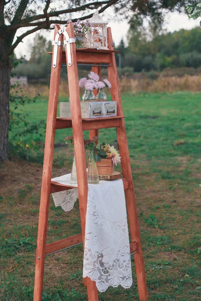 Rustic wedding photo zone. Hand made wedding decorations includes Photo Booth, wooden barrels and boxes, lanterns, suitcases and white flowers