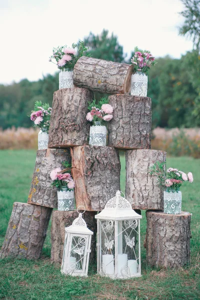 Rustic wedding photo zone. Hand made wedding decorations includes Photo Booth, wooden barrels and boxes, lanterns, suitcases and white flowers