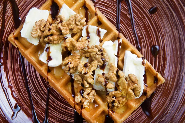Plate of belgian waffles with cheese and nuts