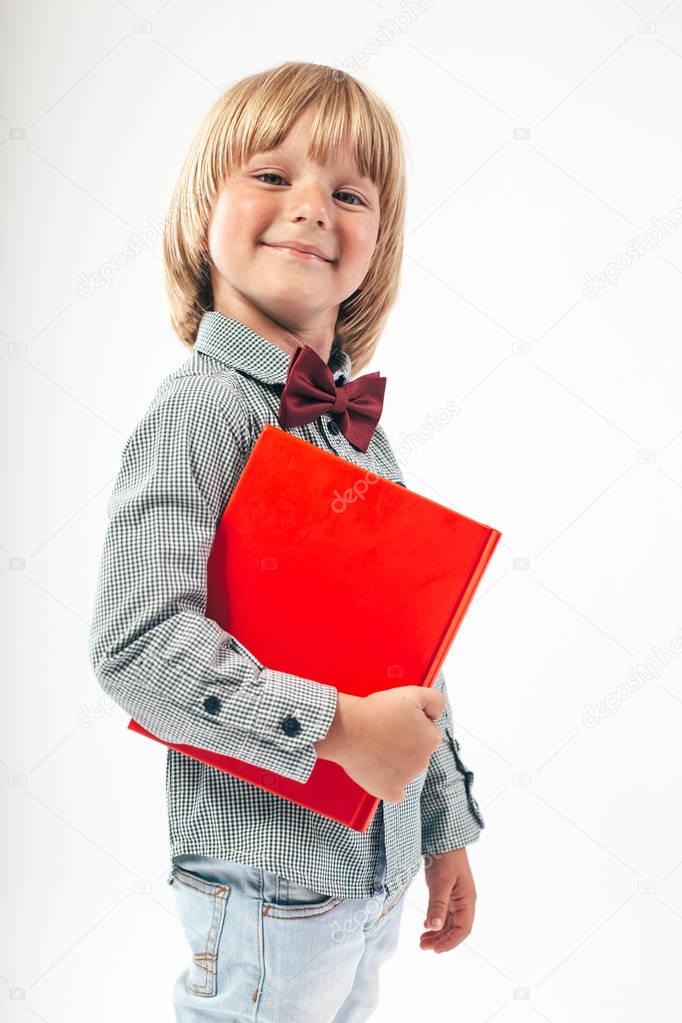 Portrait of happy schoolboy with books and apple isolated on white background. Education, isolated. School preschool