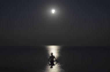 Gece denizde adam silüeti