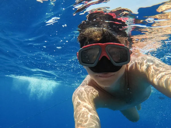 Egy ember, egy víz alatti álarccal úszik a tengeren — Stock Fotó