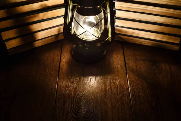 The light of kerosene lamp and books on the table
