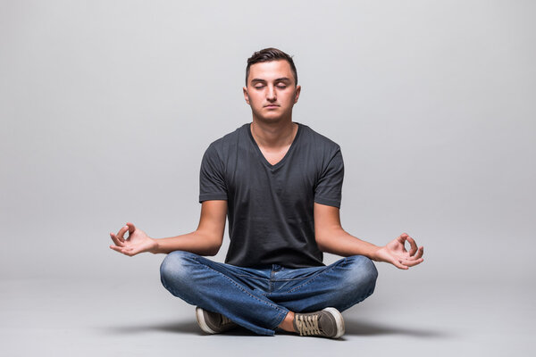 Man in casual cloth sitting in lotus position