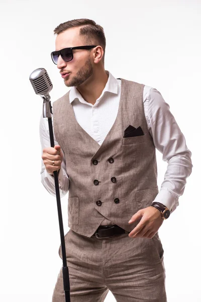 Portrait of young man in suit singing with the microphone — Stock Photo, Image