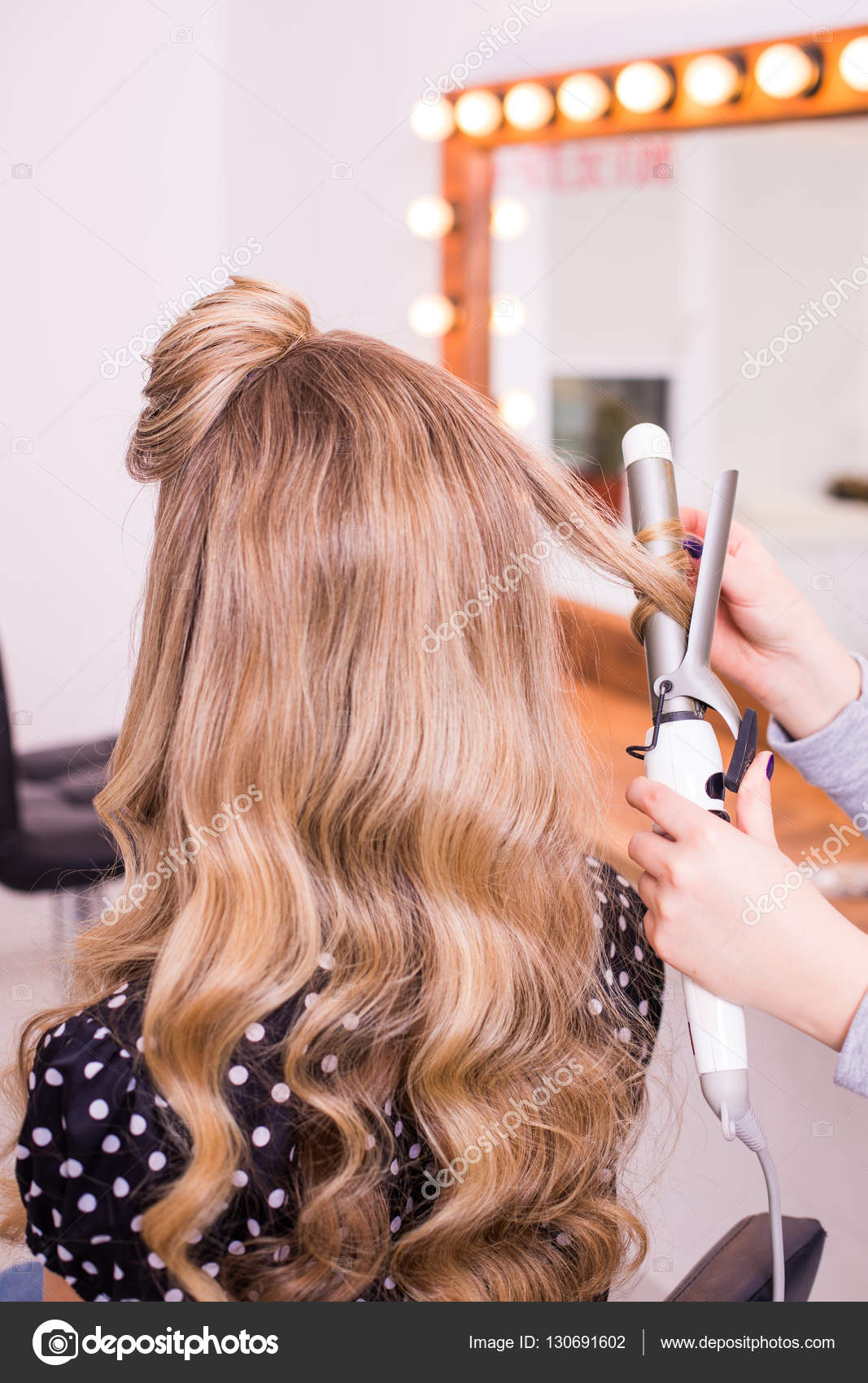 Woman Hairdresser Making Hairstyle Using Curling Iron For Long Hair Of Young Female With Smartphone In Beauty Salon Stock Photo Image By C Dan Grytsku Gmail Com 130691602