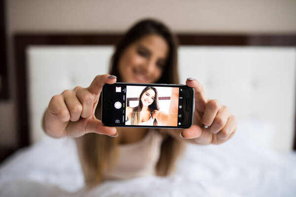 girl making selfie in the bed
