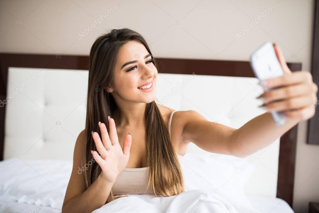 girl making selfie in the bed