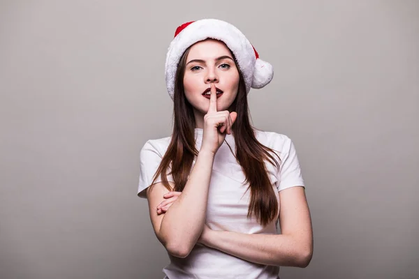 Female model wear santa hat with silence gesture — Stock Photo, Image