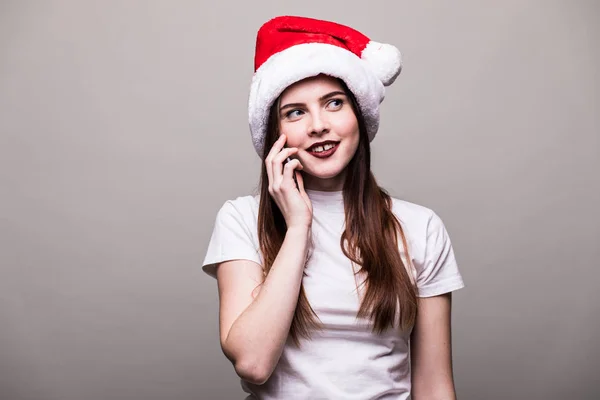 Menina com chapéu de Natal chamando no telefone . — Fotografia de Stock