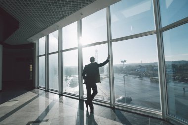 Düşünmek için zaman. İş adamı yalnız panoramik pencereli odada.