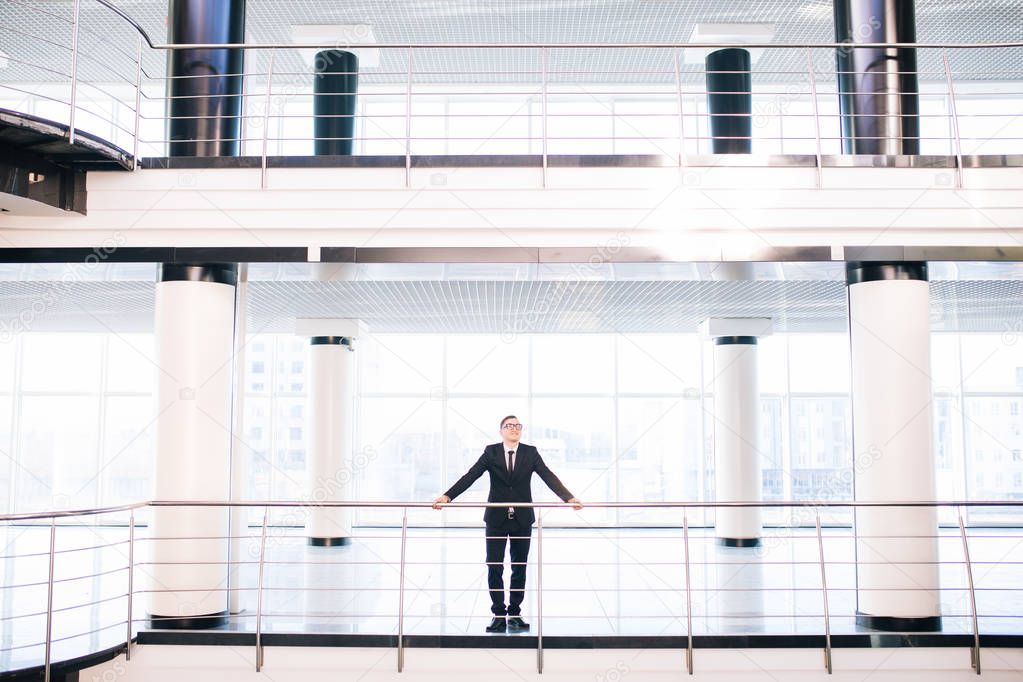  business man in big office look around all working hall