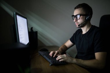 Gecenin içinde PC üzerinde çalışan adam