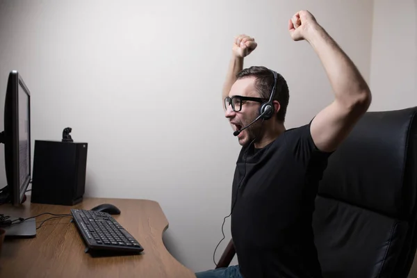 Νέος gamer ακουστικά και γυαλιά που χρησιμοποιούν τον υπολογιστή για το παιχνίδι το παιχνίδι — Φωτογραφία Αρχείου