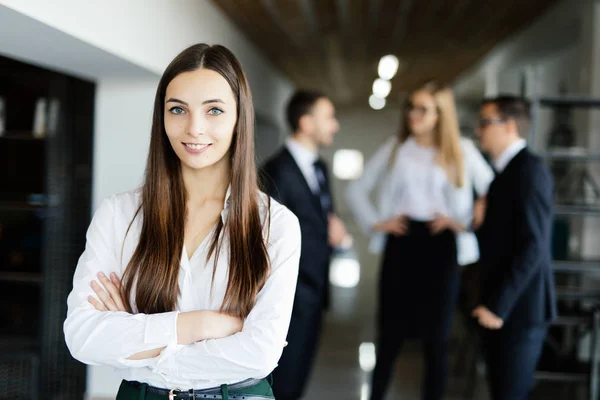 Face of beautiful woman on the background of business people — Stock Photo, Image