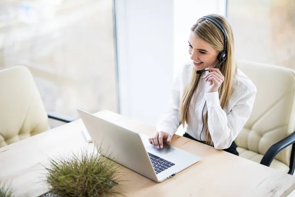 Mujer operador de atención al cliente con auriculares y sonriente — Foto de Stock