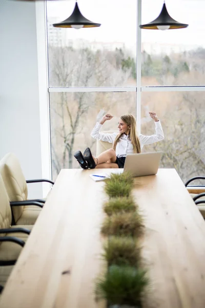 Obchodní žena uvolněná a náladu z dobře odvedené práce v kanceláři — Stock fotografie