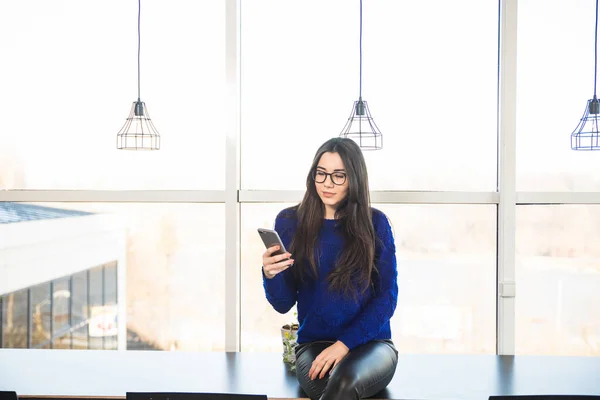 Giovane ragazza wirh telefono in ufficio moderno — Foto Stock