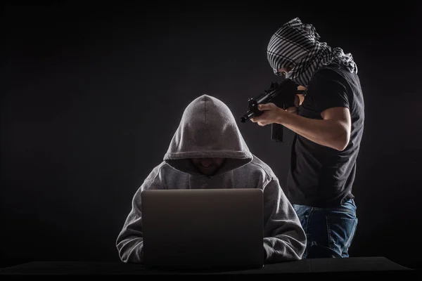 Terrorist  attack  hacker with gun work at laptop. — Stock Photo, Image