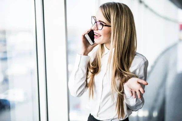 Mujer de negocios hablan teléfono cerca de ventanas panorámicas . — Foto de Stock