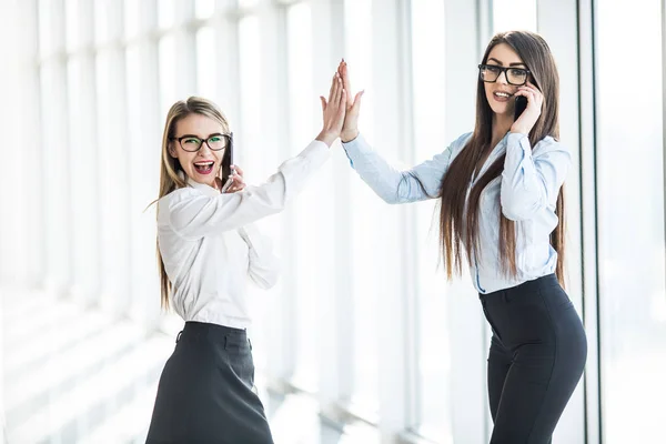 Give me high-five. Two business women giving high-five of good work.