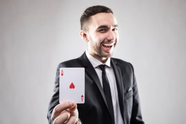 Bir ace kart tutan mutlu iş adamı