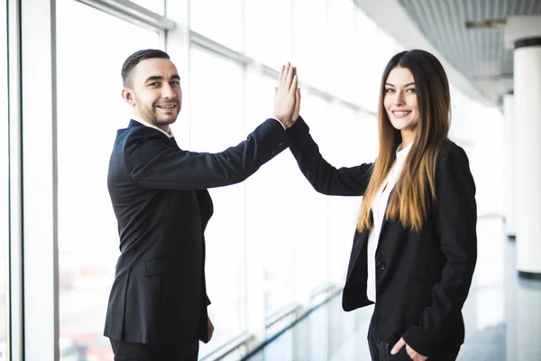 stock image Creative business couple hands up doing high five in office