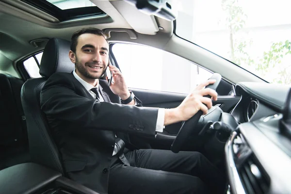 Man using his phone while driving the car. Business man driver speak phone white drive car — Stock Photo, Image