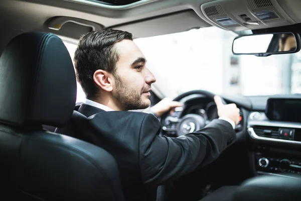 Close-up of man hands holding steering wheel while driving car — Stock Photo, Image