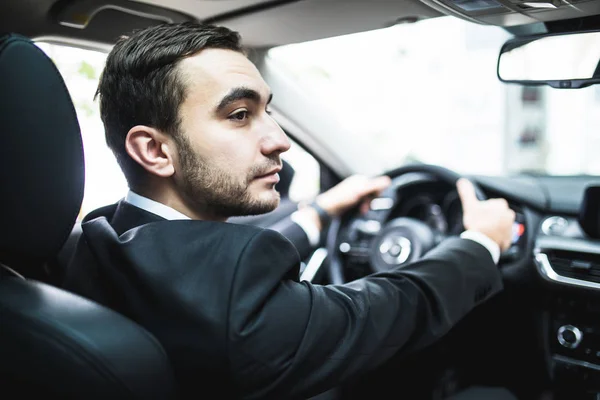 Close-up of man hands holding steering wheel while driving car — Stock Photo, Image