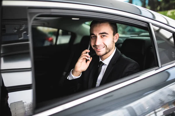 Smile businessman using his phone in his car — Stock Photo, Image