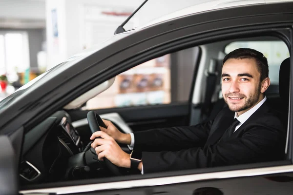 Smiling man looking from a car window — Stock Photo, Image