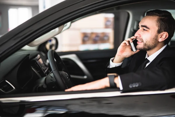Portrait of handsome business man use phone in car — Stock Photo, Image