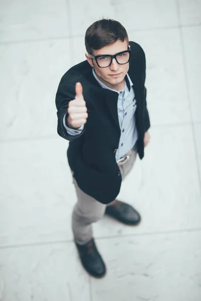 Smiling business man holding thumb up on white. top view — Stock Photo, Image