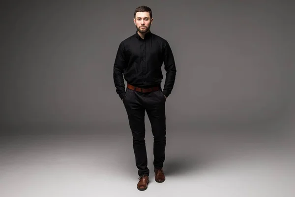 Handsome young businessman while standing — Stock Photo, Image