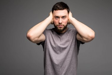 Genç adam onun kulaklarını elleriyle durdu.