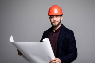 Bir mimar builder eğitim yerleşim planı odaların, ciddi inşaat mühendisi şantiye gri arka plan üzerinde belgeleriyle çalışma portresi